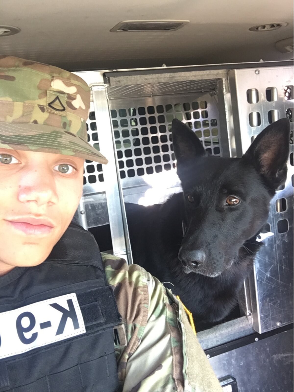 Jordan during his Army service, in K-9 gear beside his working dog partner